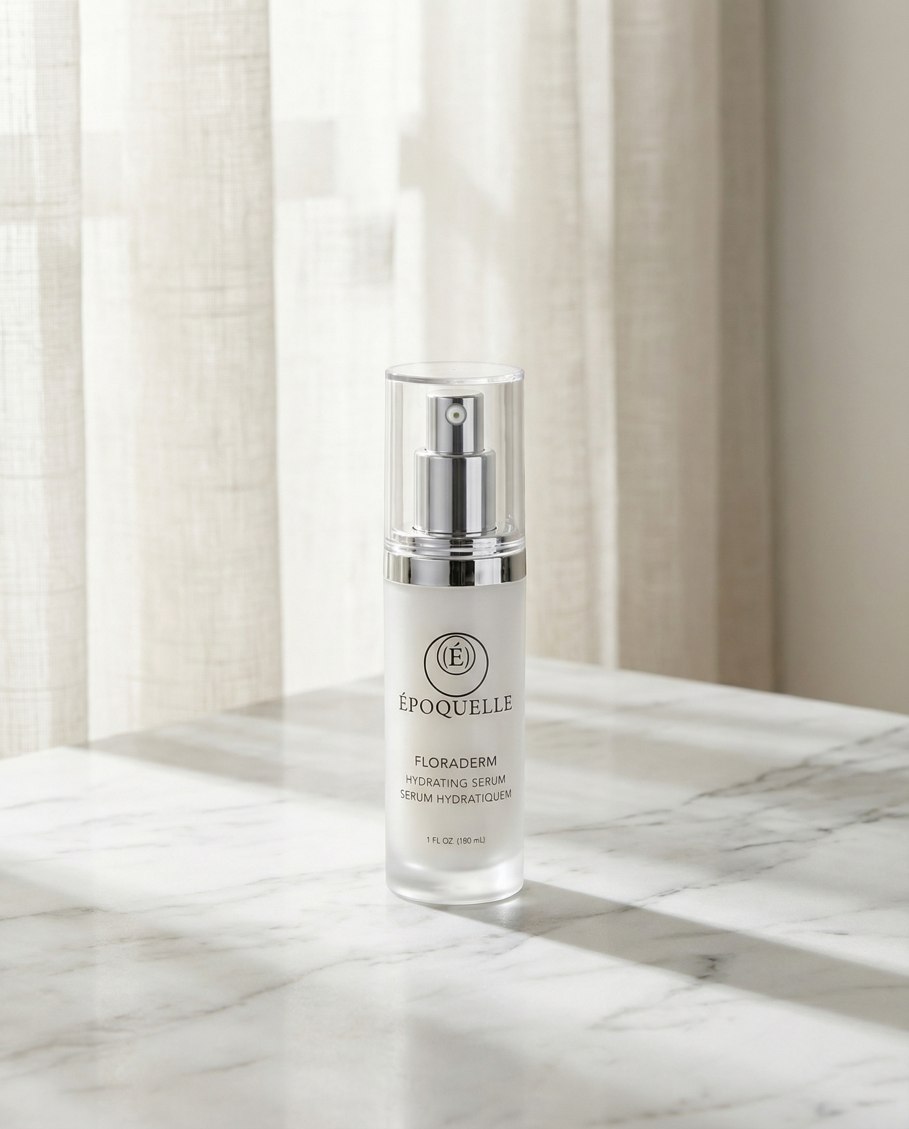 Époquelle Floraderm serum in frosted glass packaging on white marble with soft natural light